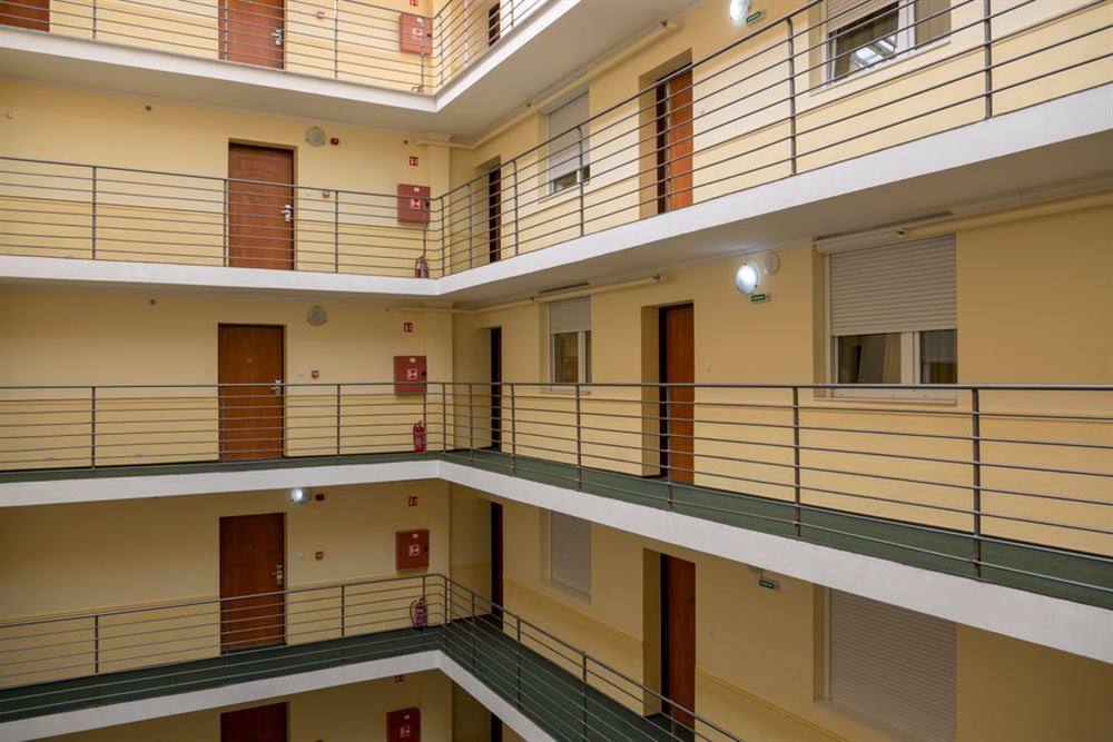Multi-story apartment building hallway showing stacked units in Houston