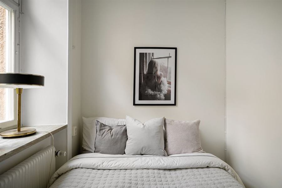 Bed placed against a shared apartment wall, a common entry point for bed bugs