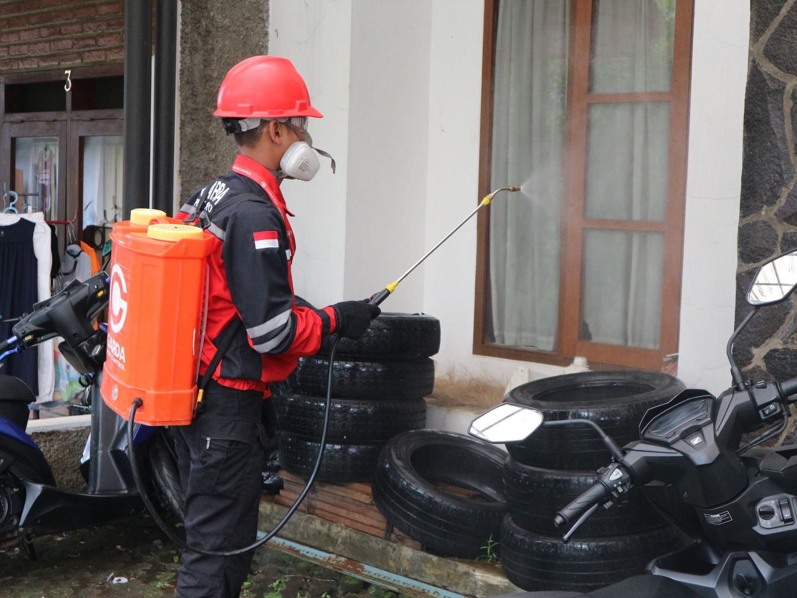 Pest control technician using a backpack low-volume sprayer